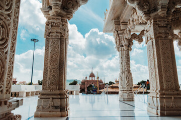 Beautiful view of carving on pillars of Swaminarayan temple with fluffy clouds at Bhuj, Kutch, India