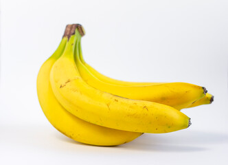 Ripe yellow bananas.A bunch of ripe bananas with dark spots on a white background.