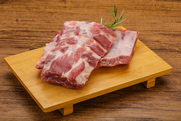 Raw pork ribs served rosemary