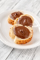 Slices of baguette with chocolate paste