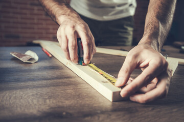 Carpenter measurement on a wooden plank