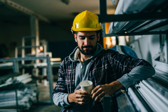 industrial worker having lunch break, drinking coffee