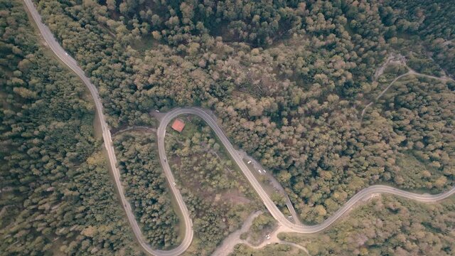 Passroad at a Mountain. Turns through forest. Aerial Birdview. Kesselberg next to Walchensee. Bavaria