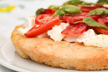 Tasty focaccia with tomato, basil and mozzarella. 