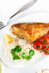 Sea bass grill with rice, greenery and cherry tomatoes. White background.