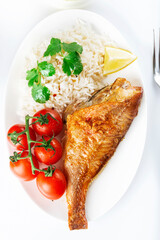Sea bass grill with rice, greenery and cherry tomatoes. White background.