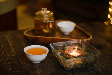 Fototapeta na wymiar A cup of Chinese tea. Kettle and candle.