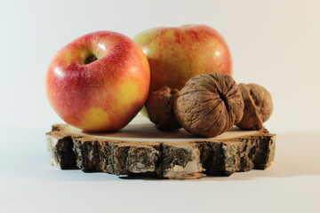 Yellow-red apples on a hemp with walnuts