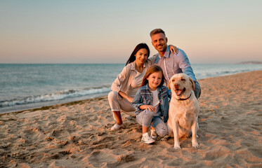 Family with dog on the beach