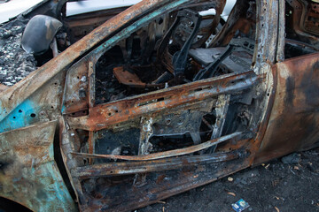 car in a parking lot burned by vandals