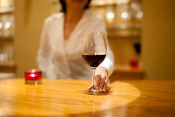 グラスを差し出すソムリエの女性
