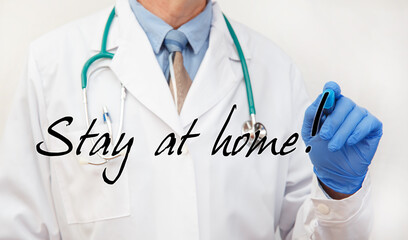 Hand writing showing Stay at home
