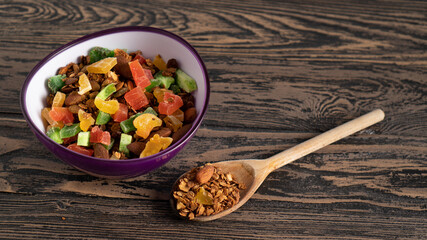 Top view of granola bowl and wooden spoon portion. Healthy hearty sweet and tasty food for breakfast. Color