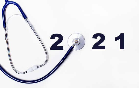 Stethoscope with number 2021 on a white background. Happy new year for health care and medical calendar banner cover. Top view, copy space. Medicine treatment and diagnosis concept.
