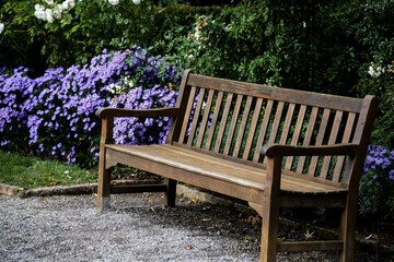 Fototapeta premium Holzbank im Blumengarten