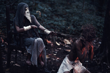 grim reaper and scary scarecrow as a slave in the dark forest. Halloween background