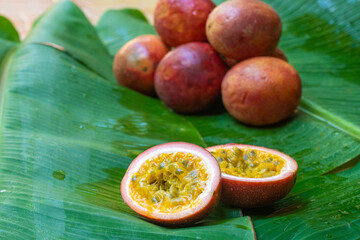 Ripe passion fruit, on a wet banana leaf. Vitamins, fruits, healthy foods