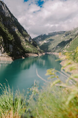 Fototapeta na wymiar amazing mountain lake scenery. Beautiful lake with hills and mountains. Montenegro, Piva Lake