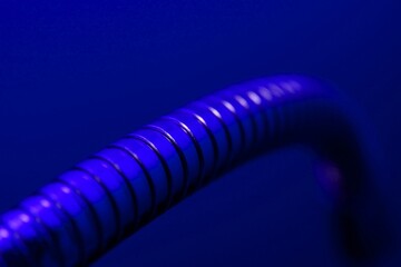 Abstract metal tube in blue light