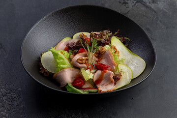 salad with duck pieces and pear slices in a plate