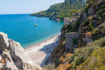 Unidentified people enjoy sea and sand in summer just near ancient city, Olympos, Antalya, Turkey.