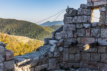 Old military dilapidated fortress on the background of a mountain pass in autumn. blurry focus