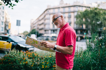 Old man with map on street