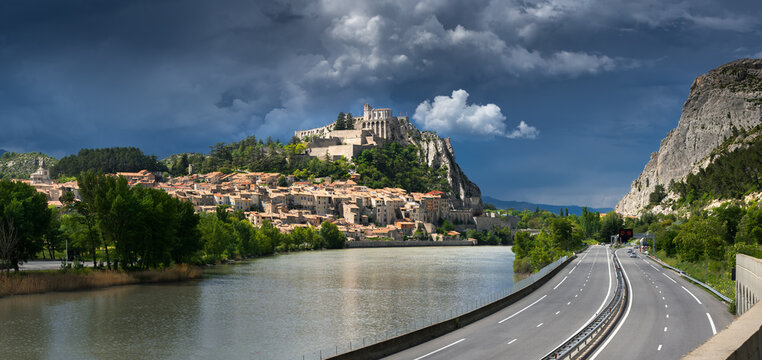 Sisteron and the Citadel (Fortifications - Historic Monument - Vauban) under stormy skies with the Durance River. Alpes de Haute Provence, France