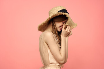 Romantic girl with pigtails and in a straw hat smile romance pink background Copy Space