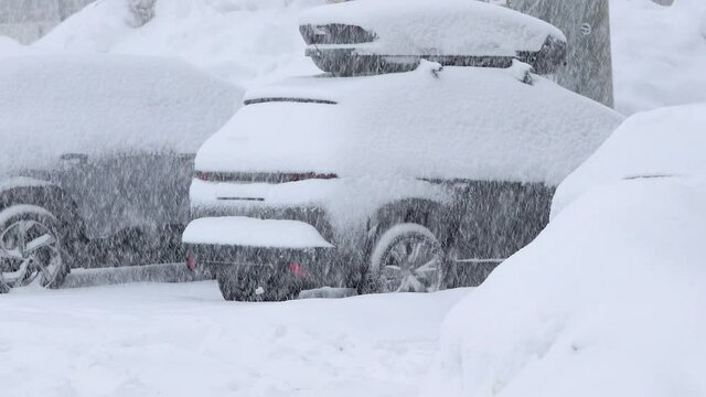 Snow falling on parking cars on a skiing resort