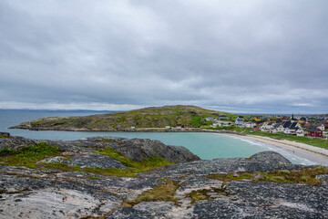Fototapeta na wymiar View from the rocks to the fishing village Bugoynes (Pykeija) and Barents Sea, Varangerfjord, Norway