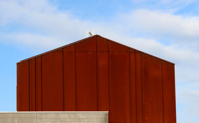 Rusted  steel lateral facade and roof, detail of a modern house.	