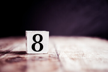 Number 8 isolated on dark background- 3D number eight isolated on vintage wooden table