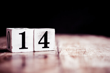Number 14 isolated on dark background- 3D number fourteen isolated on vintage wooden table