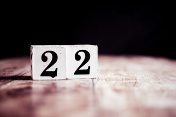 Number 22 isolated on dark background- 3D number twenty two isolated on vintage wooden table