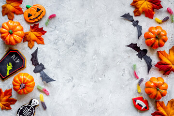 Frame of Halloween decorations with cookies and candies, top view