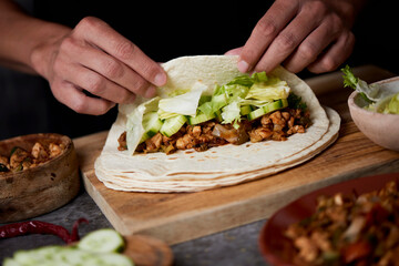 man preparing a durum or a burrito