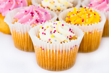 cupcake with pink frosting and sprinkles