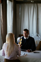 Handsome businessman dressed in the suit drinking wine. Businessman enjoying in the restaurant..