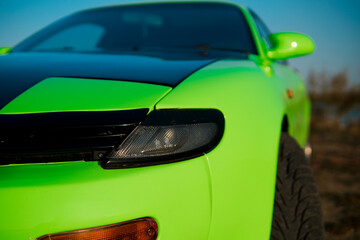 Close up of green and black sport car. Japanese oldtimer.