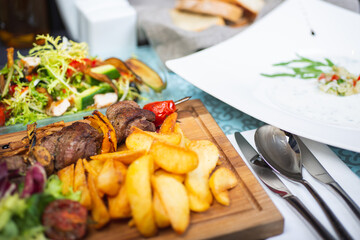 Top view of a restaurant table served with a multi-course set lunch and drink. Complex lunch.