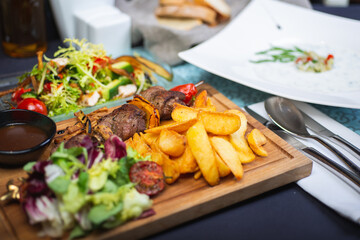 Top view of a restaurant table served with a multi-course set lunch and drink. Complex lunch.