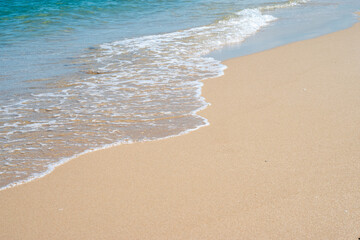 A beach with waves breaking in