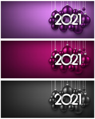 Set of 2021 sign among hanging christmas tree toys.