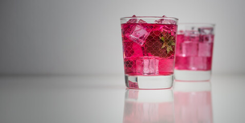 Vodka with strawberry cordial and lime lemonade in a glass