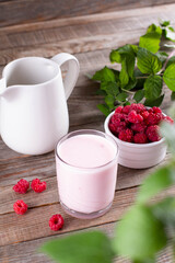 Homemade yoghurt in a glass glass with organic raspberries. Healthy and dietary food