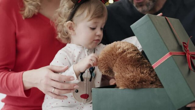 Video of toddler receiving teddy bear as Christmas gift. Shot with RED helium camera in 8K.