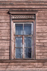 Naklejka na ściany i meble Old window of an old wooden house front view