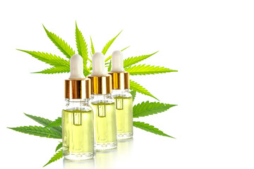 Medicinal cannabis CBD oil in a bottles with leaf isolated on white background.