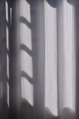 white curtain in front of window in sunny day.